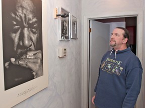 BRIAN THOMPSON, The Expositor

John Newton looks at photographs of blues guitarist Luther Allison, and the mount on the wall where Allison's vintage Fender Stratocaster once was displayed. The guitar was among numerous items stolen during a break-in at Newton's home in St. George over the Christmas holidays.