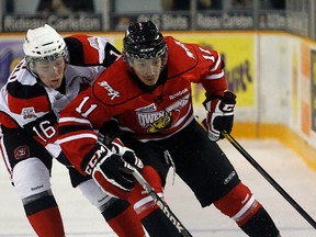 The Attack’s Cameron Brace holds off Tyler Toffoli of the Ottawa 67’s during a game played in Ottawa early last season.