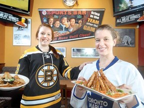 SCOTT WISHART The Beacon Herald
Boston Pizza servers Jillian Robinson, left, and Kiera DiDiomete are ready to welcome back NHL fans to the popular Erie St. eatery.