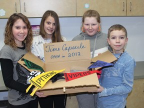 Students whose families have a long history at Reynolds School show off the time capsule that will be opened Saturday at the Reynolds 50th Anniversary Celebration; (L to R) Avery South, Lexi Lyttle, Dylan Richardson and Lucas Taylor.