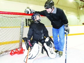 Coach Doug Reid gives some advice to novice goalie Mathew Redford during team practice Jan. 15, 2013. SARAH O. SWENSON/WETASKIWIN TIMES/QMI AGENCY