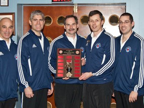 The 8 Wing players are all smiles as they accept the trophy donated by Quinte West  in the first annual bonspiel. Note the nifty track suits.