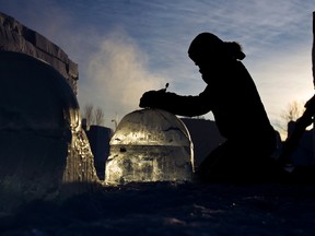 Edith Van De Wetering, above, of the Netherlands works on an ice sculpture during final preparations for Ice on Whyte at End of Steel Park last year.  CODIE MCLACHLAN QMI Agency