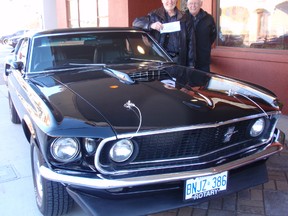 Barry Fraser, left, and Jack Pearson of the Chatham Rotary Club are shown with the 1969 Mustang Mach 1 Fastback that was raffled off Wednesday as the club's main fundraiser. The winner hailed from Kanata near Ottawa. Gross ticket sales exceeded $100,000 and the car was appraised at $30,000. Bob Boughner / CHATHAM DAILY NEWS / QMI AGENCY