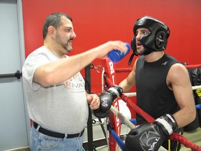 Cornwall pro boxer Tony Luis has a water break with his dad and coach Jorge, during a sparring session this week at the family-run Champs Eastside Boxing Club. Luis, 15-0 as a pro, will be in the co-feature main event Jan. 25 at the ESPN Friday Night Fights card in the U.S.
Todd Hambleton staff photo