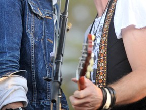 Trews bass player Jack Syperek and lead guitarist John-Angus MacDonald belt out background vocals at Rogers Bayfest last July. The Canadian rockers will back in Sarnia, playing back-to-back shows at the Industry Theatre Feb. 8 and 9. (Observer file photo)