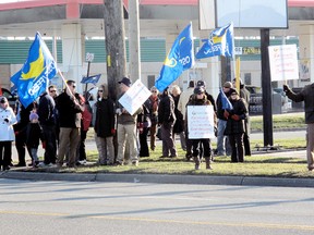 A small group of local high school teachers, along with a few elementary teachers, took part in a protest against Bill 115, Wednesday, Jan. 16, 2013, in Chatham. The legislation, which has frozen wages and cut benefits, has also enabled the provincial government to impose a contract and prohibit teachers from going on strike. The local protest was slated to be held in front of the constituency office of Chatham-Kent Essex MPP Rick Nicholls, but most teachers moved over to Keil Dr., where they received several honks of support by passing motorists. (ELLWOOD SHREVE, The Chatham Daily News)