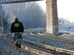 A Mohawk protester walks along the tracks near Marysville, east of Belleville, where a blockade of the CN and CP rail lines was set up Wednesday.