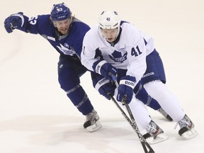 Mike Kostka (left) pushes Nikolai Kulemin off the puck during a Maple Leafs training camp scrimmage on Wednesday at the MasterCard Centre in Etobicoke. (JACK BOLAND/TORONTO SUN)