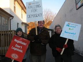 Teachers from Haldimand and Norfolk counties staged a short protest in front of MPP Toby Barrett's office in Simcoe on Wednesday. Doverwood Public School teacher Hayley Lapierre showed her support to Ontario Secondary School Teachers' Federation members, Martin MacNeil and Jacqy Keifer, both from Cayuga Secondary School. (SARAH DOKTOR Simcoe Reformer)
