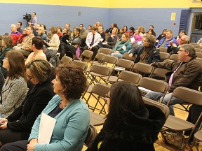 Concerned citizens attend a meeting earlier this month about the future of Kingston's three central high schools.