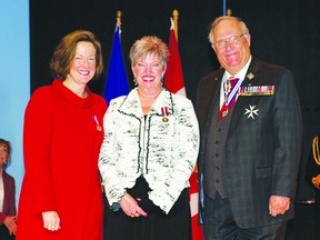 Premier Allison Redford (Left) and Donald S. Ethell, Lieutenant Governor of Alberta (right), present Karen Andrew with her Queen Elizabeth II Diamond Jubilee Medal.