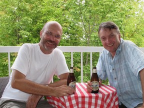 Publisher Frank B. Edwards, left, and Pat Morrow, right, author of the recently-released iBook Everest: High Expectations, take a break from photo editing at the Edwards' office this September. The book celebrates two successful Canadian attempts to climb Mount Everest in 1982 and 1986. (Photo credit: Bungalo Books)