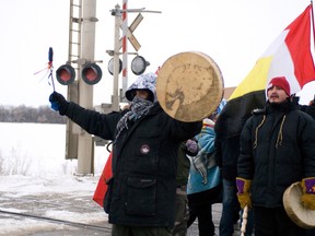 A protester, Dancing Bear, blocks traffic heading south on Highway 16, Wednesday afternoon. First Nations protesters blocked the CN Rail line as well as the highway for much of the day as part of the Idle No More protests. (ROBIN DUDGEON/PORTAGE DAILY GRAPHIC/QMI AGENCY)