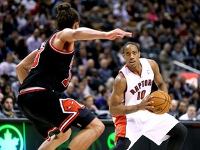 Chicago Bulls’ Joakim Noah (left) closes in on Raptors’ DeMar DeRozan last night at the Air Canada Centre. The hosts were down by 19 points in the third quarter before marching back to force overtime and eventually losing. (Ernest Doroszuk/Toronto Sun)