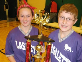 Our Lady of LaSalette students Mackenzie Featherstone (left) and Alex Burggraeve, both 13, hold the team trophy their school won Wednesday during the annual Knights of Columbus free throw event held at St. Frances school in Delhi.  (DANIEL R. PEARCE  Simcoe Reformer)