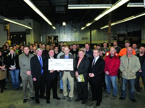M.P. Gord Brown presents Newterra company president Bob Kennedy with federal funding of $410,000 to support renovation, training and technology costs for the company to expand into the former Shorewood Packaging plant on California Avenue. (DARCY CHEEK/RECORDER AND TIMES)