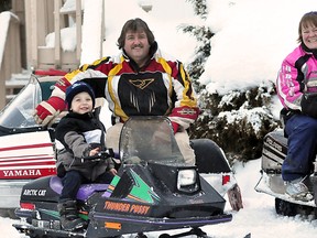 The Timmins Motoboggan Club will be hosting it's first event Saturday, an antique snowmobile show and swap meet. Club president Bob Carriere poses with his grandson Zachary Carriere and the club's vice-president Kelly Andrews on a fleet of vintage snow machines like the ones that will be featured in the event.