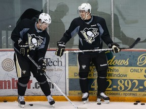 Pittsburgh Penguins' James Neal (18) jokes with teammate Sidney Crosby (R) during the first day of NHL hockey training camp at their practice facility outside Pittsburgh, Pennsylvania January 13, 2013. (REUTERS/Jason Cohn)