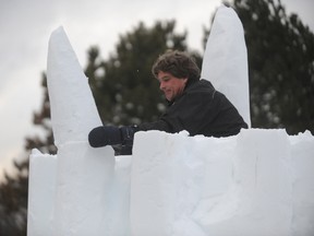 Sarnia snow sculptor Ian Washington climbed atop his 10-foot tall tree for a quick installation at the Dow People Place in Sarnia, Ont. Thursday, Jan. 17, 2013. Washington worked alongside U.S. sculptor Bob Fulks in preparation for Sarnia Snowfest. (BARBARA SIMPSON, The Observer)