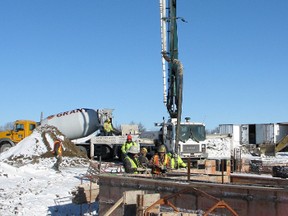 Crews work to lay concrete at the site of the King's Landing apartment building, a project that added 40 housing units to the city's tally of residential development in 2012.
Cheryl Brink staff photo