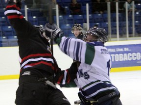 Calvin Penny, right, of the St. Marys Lincolns dumps Steve Farlow of the Sarnia Legionnaires in the second period Thursday, Jan. 17, 2013 at Sarnia Arena. (PAUL OWEN, The Observer)