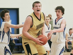 Colts centre Jonah Fogg (centre) is sandwiched between Steelhawks’ Michel Weldon (right) and Kevin Thomas (left) during action Thursday.