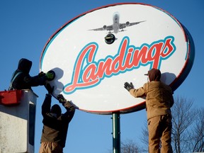 Staff from Stewart Electric replace the Kelsey's restaurant sign with a Landings sign at the restaurant Friday morning. Owner Safdar Shah has left the Kelsey's franchise behind and is now operating the restaurant independently. 
Emily Mountney QMI Agency