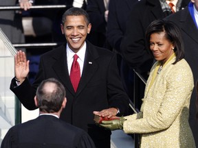 Barack Obama takes the Oath of Office as the 44th President of the United States as he is sworn in by U.S. Chief Justice John Roberts with his wife Michelle by his side during the inauguration ceremony in Washington, January 20, 2009.   REUTERS/Jim Young