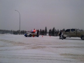 Wood Buffalo RCMP maintain a roadblock after freezing rain and black ice rendered Highway 63 and much of Highway 881 unsafe. Highway 63 was originally supposed to reopen at 8 a.m. Friday. However, the road remained unsafe as dawn came. Jacob Connolly / Supplied Photo via Twitter
