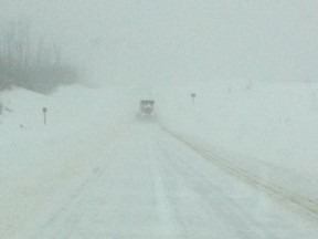 A snow plow operates in near white out conditions near Mariana Lakes on Highway 63 on Friday morning. PHOTO SUBMITTED