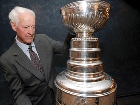 Gordie Howe eyes the Stanley Cup during the Gordie Howe and Friends Luncheon in Calgary on, April 13, 2012. Howe played professionally in six decades, his last game in 1998. 
LYLE ASPINALL/Postmedia Network FILE PHOTO