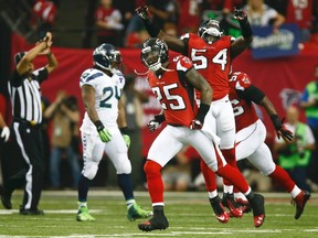 Atlanta Falcons William Moore (25) and Stephen Nicholas (54) celebrates after stopping the Seattle Seahawks on fourth down during the second quarter in their NFL NFC Divisional playoff football game in Atlanta, Georgia January 13, 2013. (REUTERS/Chris Keane)