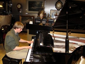 Alec Tunks has enjoyed the opportunity to play this grand piano at the Avenel Collection antique store in the Downtown Chatham Centre. He's pictured here playing on Saturday, Jan. 19, 2012, in Chatham, Ont. It's the first real piano he's played since teaching himself the skill on an electronic keyboard he found. ELLWOOD SHREVE/ THE CHATHAM DAILY NEWS/ QMI AGENCY