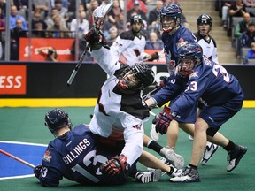 Kasey Beirnes and Gerrett Billings of the Toronto Rock take down Michael Manley of the Philadelphia Wings during last night’s game at the ACC. (DAVE ABEL/Toronto Sun)