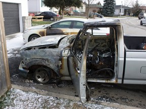 Nobody was hurt when fire damaged two vehicles and a fence at 142 Carlyle St. in London Sunday. (DEREK RUTTAN, The London Free Press)
