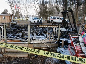 Investigators with the Ontario Fire Marshal Office, Tyendinaga Mohawk Police and the OPP are hoping to determine the cause of a cottage fire that left two people dead and one man fighting for his life at 180 Snookies Rd, in Shannonville, Ont. Friday, Jan. 18, 2013. (Photograph taken Sunday, Jan. 20, 2013). JEROME LESSARD/The Intelligencer/QMI Agency