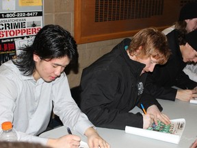 (L to R) Godric Tham and Sheldon Argent of the Melfort Mustangs signed autographs on Saturday, January 19.