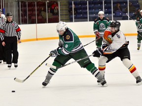 QMI photo

Dave Hominuk (8) of the Whalers tries to get away from a Blast check during Saturday night's Allan Cup Hockey game in Welland.