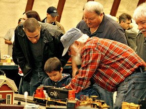 KARA WILSON,  for The Expositor

Ray Hoaley shows four-year-old Ethan Barnett how to use the controls of a train during the annual Paris Junction Model Train Show at the Paris fairgrounds on Sunday.
