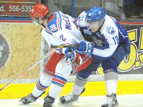 Sudbury Wolves Chad Thibodeau keeps in close check with Kitchener Rangers Evan McEneny during third period OHL hockey action from the Sudbury Community Arena on Sunday afternoon.
GINO DONATO/THE SUDBURY STAR