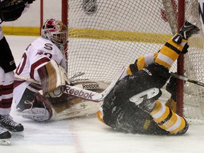 Kingston Frontenacs' Sam Povorozniouk crashes into Guelph Storm goalie Garret Sparks during Ontario  Hockey League action at the K-Rock Centre  on Sunday. (Ian MacAlpine The Whig-Standard)