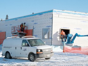 Crews install siding on the exterior of the new OPP Forensics Lab next to the force’s Highway 17 detachment in  January 2012.

FILE PHOTO/Daily Miner and News