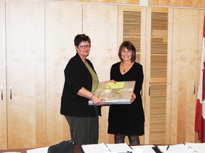 Judy Muir, Northern Gateway School Division board chair, presents retiring assistant school superintendent Bonnie Crane with a gift of appreciation for her 35 years of service with the division. 
Barry Kerton | Whitecourt Star