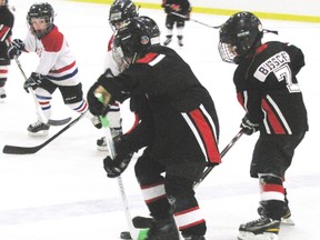Kolby Langdale; left; and Danika Bussche of the Mayerthorpe Little Stars form a tight defence against Whitecourt Rampage players in an initiation game at the 7th Annual Dakota Memorial Hockey Tournament on Saturday, Jan. 19, at the Mayerthorpe Exhibition Centre.