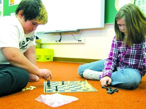 Elmer Elson Elementary School Grade 5 students Conrad
Tordzik, left, and Jesse Mosher play chess, one of the
house league board games competitions on Tuesday,
Jan. 15.