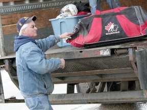 Bob Walker, left, loads donated hockey and skating equipment into the back of a Whitecourt Transport truck driven by Tad Waters, right.
Whitecourt Star