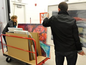 Shelly Mallon and Dale Workman move pieces of art into the Judith and Norman Alix Art Gallery for the upcoming exhibition Fluid Explorations. It features work by Sarnia-Lambton artists Josy Britton, Ariel Lyons, Jane Hunter and Marlis Saunders. All four are members of the Canadian Society of Painters in Water Colour. The exhibition opens Feb. 1, 6 p.m., at the public art gallery in Sarnia's downtown. SUBMITTED PHOTO