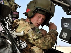Britain's Prince Harry sits in the cockpit of his Apache helicopter in Camp Bastion, southern Afghanistan in this photograph taken October 31, 2012, and released January 21, 2013. (REUTERS/John Stillwell/Pool)