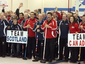 Team Scotland and Team Canada curlers pose for a group photo prior to playing off in the Sherwood Park leg of the cross-country Strathcona Cup tour. Canada avoided being swept with wins in two of the eight matches. Photo by Shane Jones/Sherwood Park News/QMI Agency